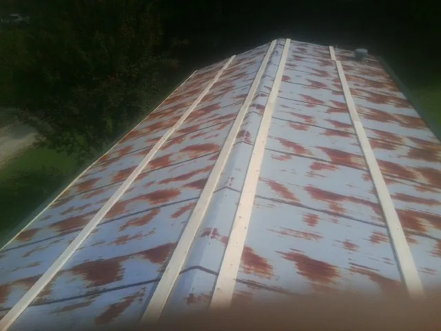 Rusted metal roof panels with new wood purlins before replacement — Storm Damage Roof Repair in Mango by Roofing Brothers